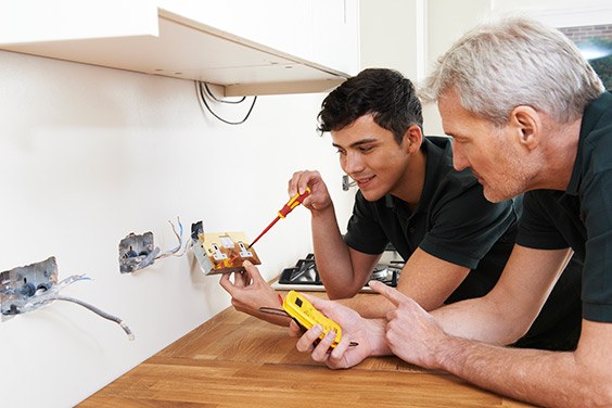 electricians in Baltimore replacing an old electrical outlet